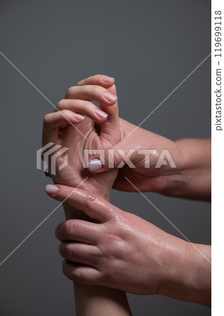 The masseuse massages the client's palms. Close-up of hands at a spa treatment. Vertical photo. The masseuse massages the client's palms. Close-up of hands at a spa treatment. Vertical photo. 119699118