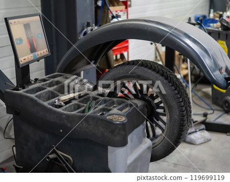 Wheel being balanced in a car workshop. Wheel being balanced in a car workshop. 119699119