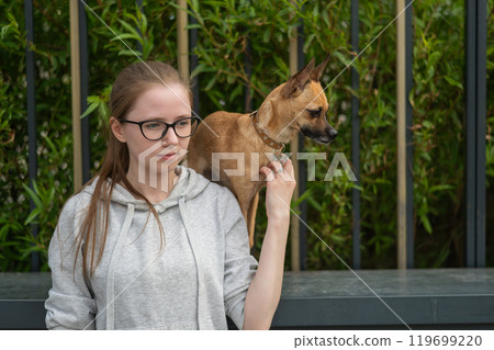 Young Caucasian woman and cute little dog walking. Young Caucasian woman and cute little dog walking. 119699220
