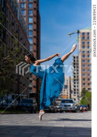 Beautiful Asian ballerina dancing outdoors. Urban landscape. 119699415