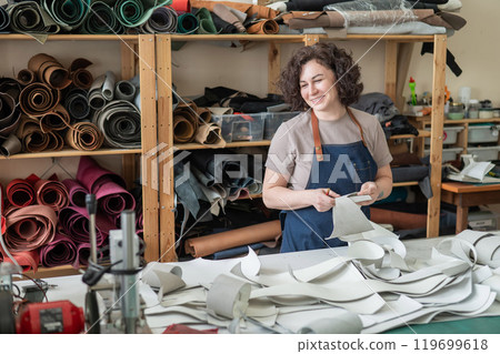 Woman tanner at work in the workshop. Woman tanner at work in the workshop. 119699618
