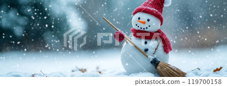 Playful snowman with a broom in a snowy landscape under a bokeh light backdrop, inviting and festive for the holiday season. 119700158