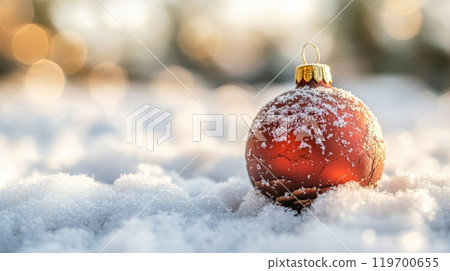 Snow-covered red Christmas bauble in soft focus. Dreamy holiday scene. Snow-covered red Christmas bauble in soft focus. Dreamy holiday scene. 119700655
