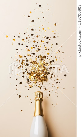 White champagne bottle with gold stars bursting on a light beige background. Ideal for Christmas and New Year celebrations. 119700905