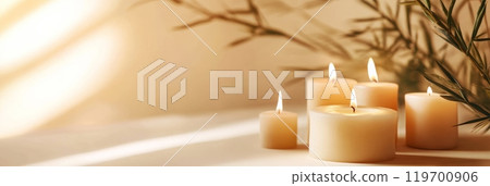 Five burning candles on a table with green bamboo plant, creating a relaxing and peaceful atmosphere. Perfect for spa, meditation or wellness concepts Five burning candles on a table with green bamboo plant, creating a relaxing and peaceful atmosphere. Perfect for spa, meditation or wellness concepts 119700906