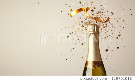 Champagne bottle with golden confetti and ribbons celebrating New Year's Eve. 119701018