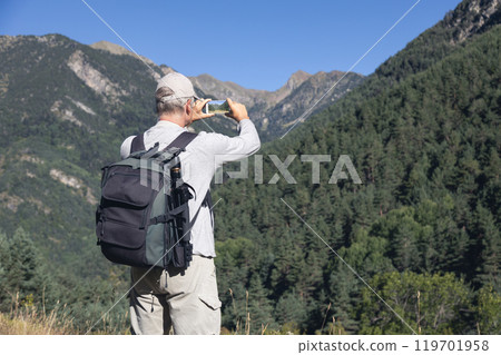 Mid old caucasian tourist man take a picture from Spanish Pyrenees mountain with mobile phone Mid old caucasian tourist man take a picture from Spanish Pyrenees mountain with mobile phone 119701958
