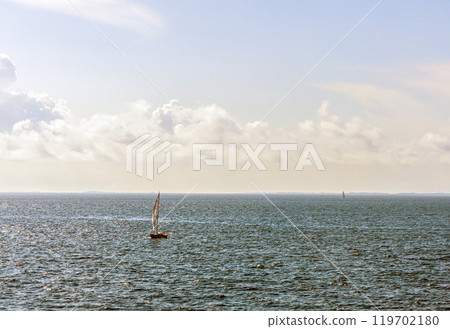 Sailboat at sea on a sunny day. 119702180