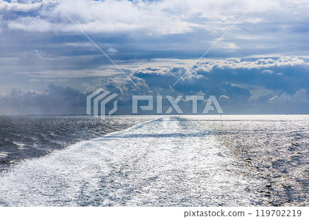 Water trail behind cruise ship. 119702219