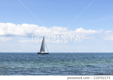 Beautiful seascape. Sailboat floats on the blue sea. Beautiful seascape. Sailboat floats on the blue sea. 119702273