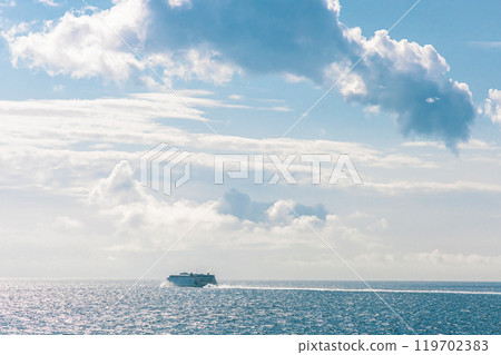 White cruise ship at sea on a sunny day. 119702383