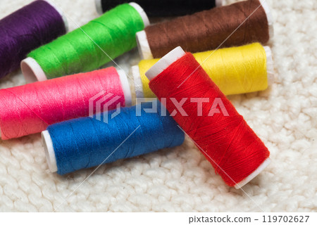 Set of colorful spools of thread close up Set of colorful spools of thread close up 119702627