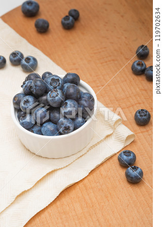 Fresh blueberries in a bowl on a wooden table. Wild berries, Healthy eating 119702634