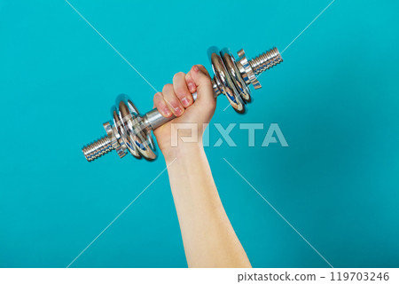 Male hand holding heavy dumbbells 119703246