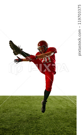 Full-length vertical image of man, American football player in red uniform in motion on field, training with intensity and focus 119703375