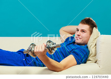 Young man fit body relaxing on couch after training Young man fit body relaxing on couch after training 119703440
