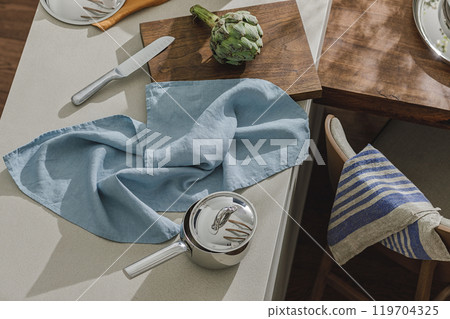 stainless still pot, artichoke on wooden board, linen towels. Healthy food cooking ingredients background with fresh vegetables stainless still pot, artichoke on wooden board, linen towels. Healthy food cooking ingredients background with fresh vegetables 119704325