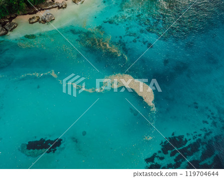 Trash in ocean water. Ocean pollution, plastic in water on Bali. Aerial view. 119704644
