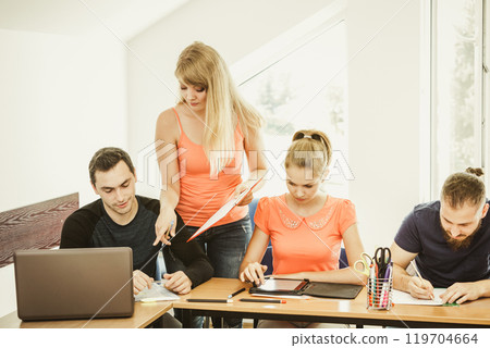 Students and teacher tutor in classroom 119704664