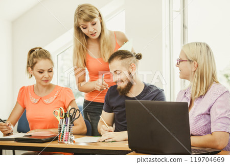 Students and teacher tutor in classroom Students and teacher tutor in classroom 119704669