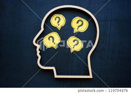 Head with question marks inside symbolizing uncertainty or curiosity. 119704876