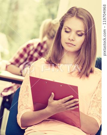 Student girl in front of her mates in classroom 119704968