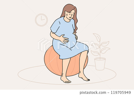 Pregnant woman feels contractions and labor is approaching, sits on fitness ball 119705949