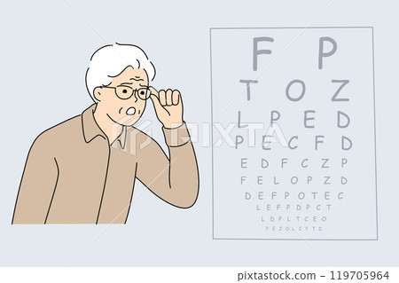 Vision test for elderly man looking at table with letters at appointment with ophthalmologist 119705964