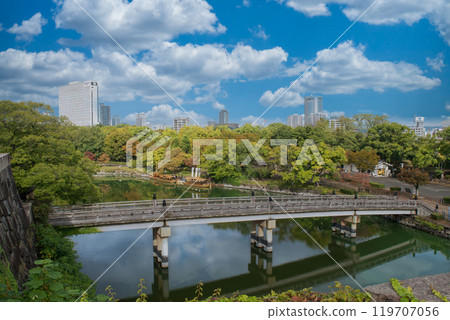 Gokurakubashi Bridge and office buildings in Osaka Castle Park 119707056