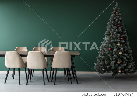 Elegant dining area with minimalist christmas tree against green wall 119707484