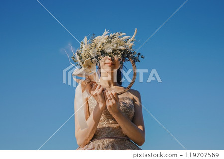 Bride with a bouquet under the blue sky 119707569