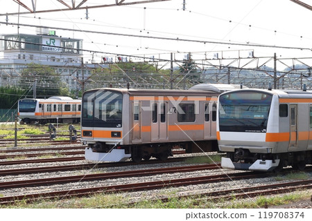 Chuo Line: E233 series and 209 series trains parked at Toyota Vehicle Center 119708374