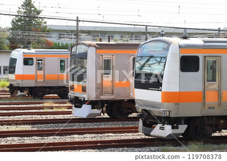 Chuo Line: E233 series and 209 series trains parked at Toyota Vehicle Center 119708378