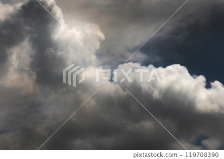 Dramatic dark storm rain clouds black sky background. Dark thunderstorm clouds rainny atmosphere. Meteorology danger windstorm disasters climate. Dark cloudscape storm disaster gloomy gray cloud sky 119708390