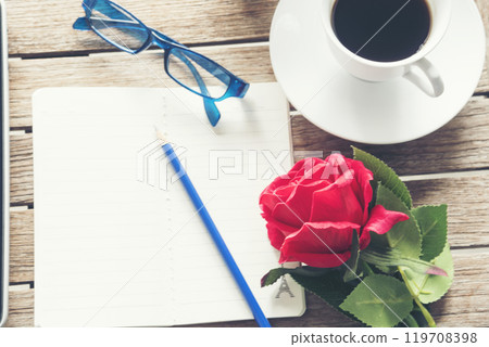 Top view office desk smart tablet document paper, coffee cup roses on wood table with copy space. Tabletop notebook office empty blank white paper pen coffee cup to display workspace wood background Top view office desk smart tablet document paper, coffee cup roses on wood table with copy space. Tabletop notebook office empty blank white paper pen coffee cup to display workspace wood background 119708398
