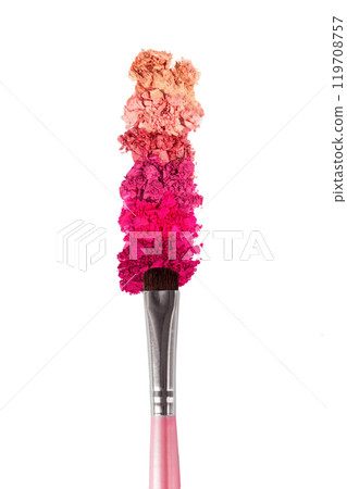 On the background of a makeup brush a sample of cosmetics with a powder texture 119708757