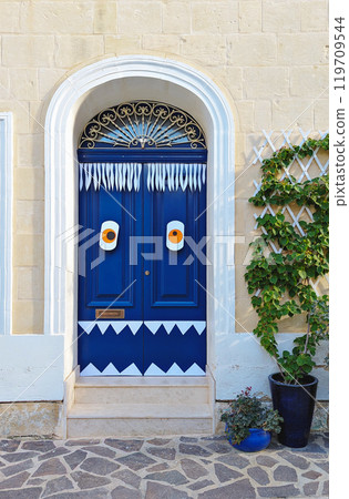 Funny Blue door with spooky monster decorations for Halloween. Funny Blue door with spooky monster decorations for Halloween. 119709544