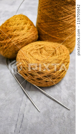 Orange threads for handicrafts. Selecting a color palette for knitting. Autumn Orange threads for handicrafts. Selecting a color palette for knitting. Autumn 119709842