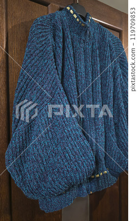 Handmade knitted products. Knitted fabric made of dark threads. Woman pullover. Handmade knitted products. Knitted fabric made of dark threads. Woman pullover. 119709853