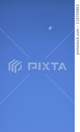 Blue sky and moon in the center, warm autumn day. Blue sky and moon in the center, warm autumn day. 119709863