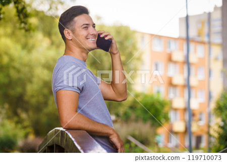 Young man talking on smartphone outdoor Young man talking on smartphone outdoor 119710073