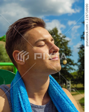 Young man relaxing after outdoor workout Young man relaxing after outdoor workout 119710090