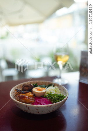 Japanese famous delicious ramen with different ingredients Noodle soup with shiitake, egg and pak choi cabbage on dark background. 119710439