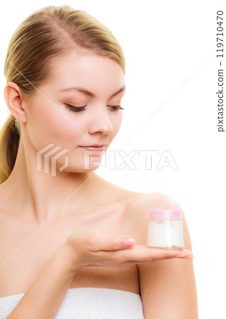 Skin care. Girl applying moisturizing cream. 119710470