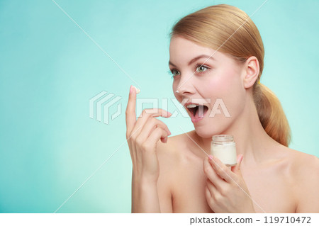 woman applying cream on her skin face. woman applying cream on her skin face. 119710472