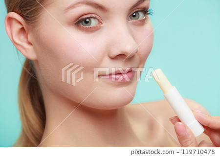 woman applying balsam for lips woman applying balsam for lips 119710478