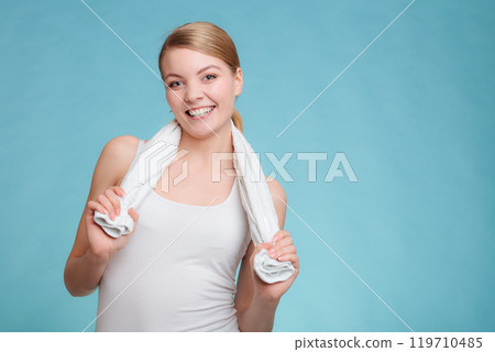 Smiling woman in white top hold towel. 119710485