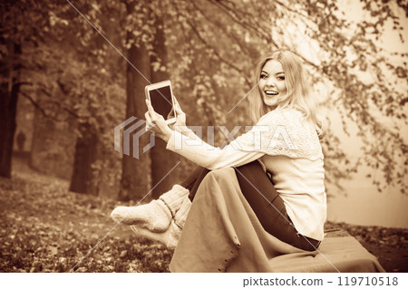 Young blonde girl in park. 119710518