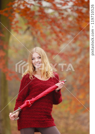 Fashion woman with umbrella relaxing in fall park. Fashion woman with umbrella relaxing in fall park. 119710526