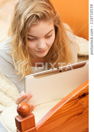Young woman girl with tablet browsing internet. 119710539